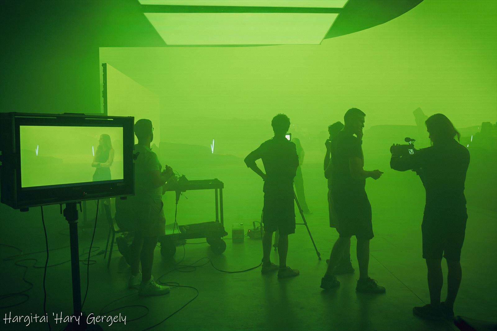 Crew silhouettes in green haze on the LED volume