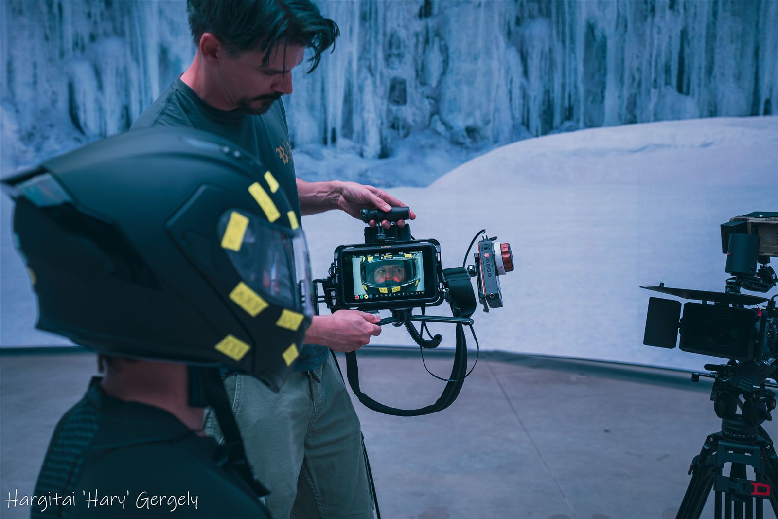 Space helmet prop in the foreground while an operator checks the monitor at the ice wall environment