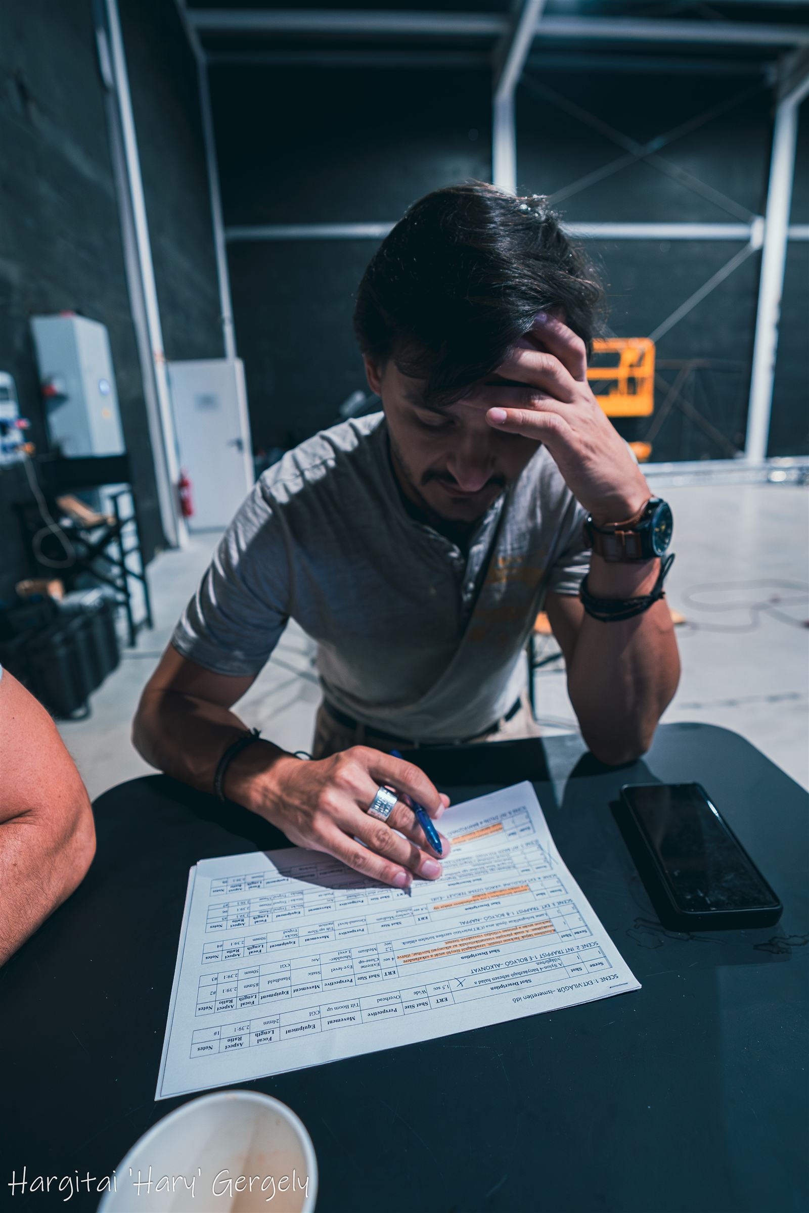Director working through the shot list at a table in the studio