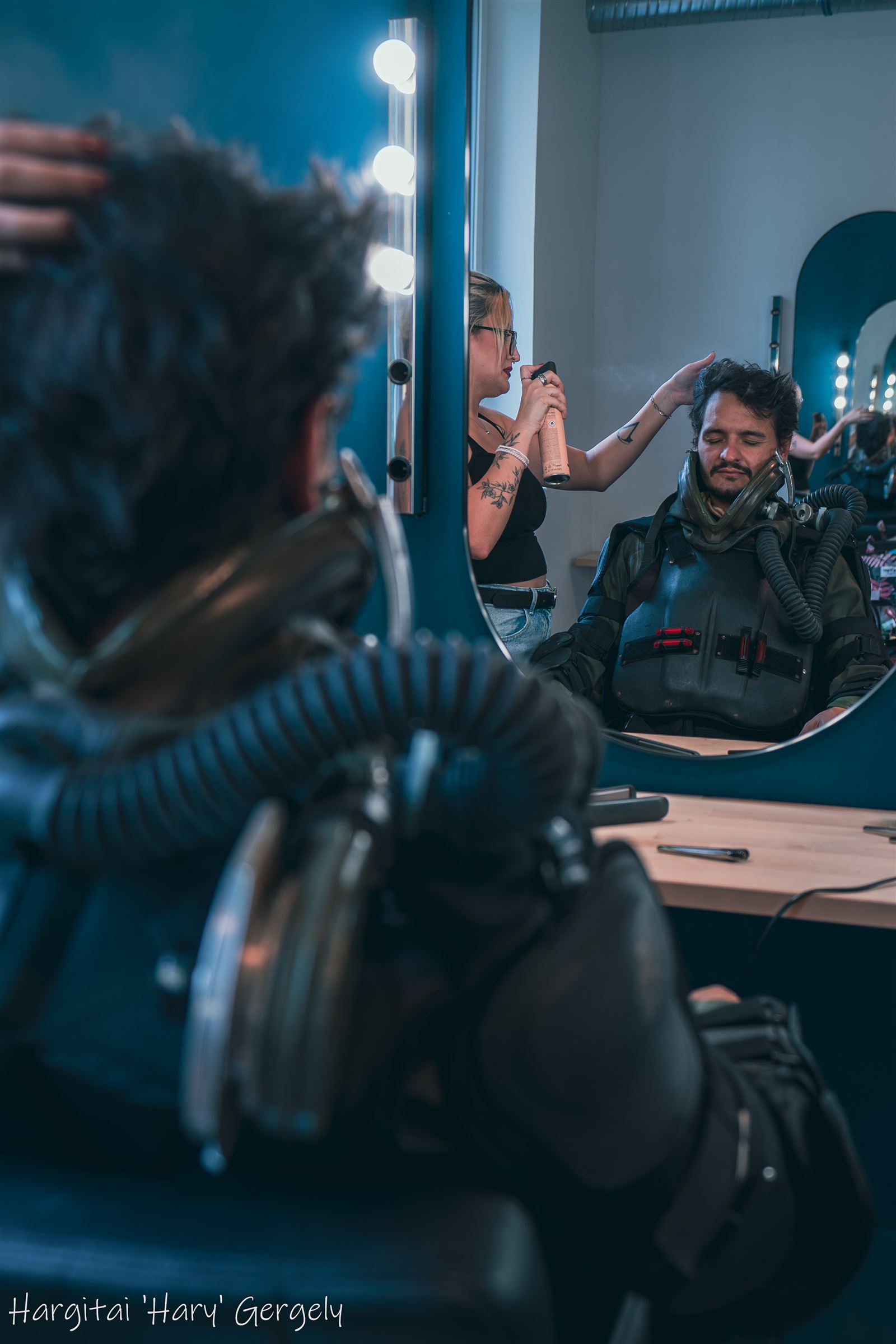 Actor in Jackson's suit with breathing rig, seen in the make-up mirror